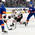 Oct 8, 2026; Elmont, New York, USA; New York Islanders defenseman Adam Pelech (3) steals the puck from Chicago Blackhawks center Frank Nazar (91) defended by New York Islanders right wing Simon Holmstrom (92) during the first period at UBS Arena.