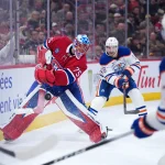 Dec 14, 2025; Montreal, Quebec, CAN; Montreal Canadiens goalie Jakub Dobes (75) clears the puck under pressure from Edmonton Oilers forward Zach Hyman (18) and forward Connor McDavid (97) during the third period at the Bell Centre.
