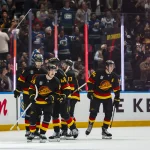 Oct 3, 2026; Vancouver, British Columbia, CAN; Vancouver Canucks forward Aatu Raty (54) celebrates his goal with defenseman Jamieson Oleksiak (4) and forward Linus Karlsson (94) and defenseman Filip Hronek (17) and forward Elias Pettersson (40) against the Calgary Flames in the third period at Rogers Arena.