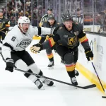 Oct 10, 2026; Las Vegas, Nevada, USA; Los Angeles Kings defenseman Joel Edmundson (6) and Vegas Golden Knights center Jack Eichel (9) chase after the puck in the third period at T-Mobile Arena. Mandatory Credit: Candice Ward-Imagn Images