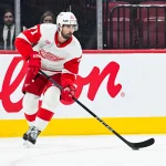 Oct 10, 2026; Montreal, Quebec, CAN; Detroit Red Wings center Dylan Larkin (71) plays the puck against the Montreal Canadiens during the second period at Bell Centre.