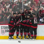 Apr 18, 2026; Raleigh, North Carolina, USA; Carolina Hurricanes left wing Taylor Hall (71) is congratulated by defenseman Alexander Nikishin (21) defenseman Shayne Gostisbehere (4) center Logan Stankoven (22) and right wing Jackson Blake (53) after his goal against the Ottawa Senators during the third period in game one of the first round of the 2026 Stanley Cup Playoffs at Lenovo Center.
