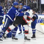 Dec 27, 2025; Toronto, Ontario, CAN; Toronto Maple Leafs defenseman Chris Tanev (8) clears Ottawa Senators forward Brady Tkachuk (7) away from the front of the net during the second period at Scotiabank Arena.