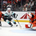 Dec 22, 2025; Anaheim, California, USA; Seattle Kraken right wing Jacob Melanson (63) attacks the net against Anaheim Ducks goaltender Lukas Dostal (1) during the first period at Honda Center.
