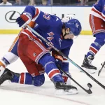 Sep 22, 2026; New York, New York, USA; New York Rangers forward Cole Beaudoin (53) fights for control of the puck in the second period against the New York Islanders at Madison Square Garden.