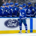 Oct 3, 2026; Toronto, Ontario, CAN; Toronto Maple Leafs center Auston Matthews (34) celebrates at the bench after scoring a goal against the Ottawa Senators during the second period at Scotiabank Arena.