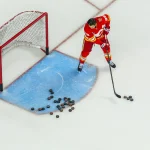 Oct 8, 2026; Calgary, Alberta, CAN; Calgary Flames defenseman Zach Whitecloud (28) passes the pucks during the warmup period against the Colorado Avalanche at Scotiabank Saddledome.