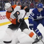 Mar 2, 2026; Toronto, Ontario, CAN; Philadelphia Flyers defenseman Rasmus Ristolainen (55) battles with Toronto Maple Leafs forward Easton Cowan (53) to get control of the puck during the third period at Scotiabank Arena.