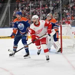 Dec 11, 2025; Edmonton, Alberta, CAN; Red Wings right winger Alex DeBrincat (93) and Edmonton Oilers defenseman Alec Regula (75) are seen out on the ice during the second period at Rogers Place.