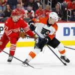 Mar 28, 2026; Detroit, Michigan, USA; Philadelphia Flyers right wing Matvei Michkov (39) skates with the puck defended by Detroit Red Wings defenseman Simon Edvinsson (77) in the third period at Little Caesars Arena.