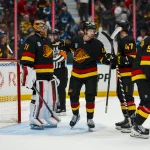 Oct 3, 2026; Vancouver, British Columbia, CAN; Vancouver Canucks goalie Leevi Merilainen (31) and forward Elias Pettersson (40) and forward Paul Cotter (47) and defenseman Tom Willander (5) celebrate the victory against the Calgary Flames at Rogers Arena.