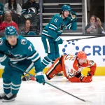 Sep 24, 2026; San Jose, California, USA; San Jose Sharks defenseman Sam Dickinson (6) checks Anaheim Ducks center Roger McQueen (95) during the first period at SAP Center at San Jose.