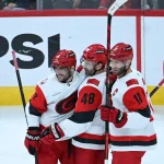 Oct 10, 2026; Chicago, Illinois, USA; Carolina Hurricanes left wing Jordan Martinook (48) celebrates with defenseman Shayne Gostisbehere (4) and center Jordan Staal (11) after scoring a goal against the Chicago Blackhawks during the third period at the United Center.