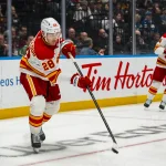 Oct 3, 2026; Vancouver, British Columbia, CAN; Calgary Flames defenseman Zach Whitecloud (28) makes a pass against the Vancouver Canucks in the second period at Rogers Arena.