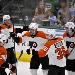 Mar 22, 2025; Dallas, Texas, USA; Philadelphia Flyers center Ryan Poehling (25) and right wing Travis Konecny (11) and right wing Matvei Michkov (39) and defenseman Emil Andrae (36) and right wing Travis Konecny (11) celebrates after Poehling scores a goal against the Dallas Stars during the second period at the American Airlines Center.