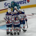 Feb 28, 2026; San Jose, California, USA; Edmonton Oilers center Trent Frederic (10) celebrates after scoring against the San Jose Sharks with teammates Edmonton Oilers defenseman Spencer Stastney (24) and Edmonton Oilers defenseman Ty Emberson (49) and teammates during the third period at SAP Center at San Jose.