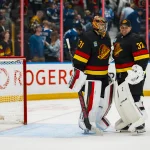 Oct 3, 2026; Vancouver, British Columbia, CAN; Vancouver Canucks goalie Leevi Merilainen (31) and goalie Kevin Lankinen (32) celebrate the victory against the Calgary Flames at Rogers Arena.