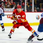 Apr 14, 2026; Calgary, Alberta, CAN; Calgary Flames center Connor Zary (47) controls the puck against the Colorado Avalanche during the second period at Scotiabank Saddledome