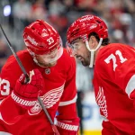 Oct 9, 2026; Detroit, Michigan, USA; Detroit Red Wings center Dylan Larkin (71) and left wing Viktor Arvidsson (33) confer during a stoppage in play in the second period against the Seattle Kraken at Little Caesars Arena.