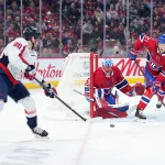 Feb 28, 2026; Montreal, Quebec, CAN;Montreal Canadiens goalie Jakub Dobes (75) stops Washington Capitals forward Pierre-Luc Dubois (80) withvthe help of teammate defenseman Kaiden Guhle (21) during the first period at the Bell Centre.