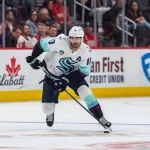 Oct 9, 2026; Detroit, Michigan, USA; Seattle Kraken center Matty Beniers (10) carries the puck in the third period against the Detroit Red Wings at Little Caesars Arena.