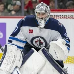 Nov 25, 2024; Saint Paul, Minnesota, USA; Winnipeg Jets goalie Connor Hellebuyck (37) tracks the play against the Minnesota Wild during the second period at Xcel Energy Center.