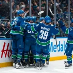 Apr 14, 2026; Vancouver, British Columbia, CAN; Vancouver Canucks forward Elias Pettersson (40) and forward Jake DeBrusk (74) and forward Curtis Douglas (42) and defenseman Filip Hronek (17) and forward Nils Hoglander (21) and forward Aatu Raty (54) and defenseman Zeev Buium (24) and forward Liam Ohgren (92) and forward Ty Mueller (39) celebrate DeBrusk's game winning goal overtime goal against the Los Angeles Kings at Rogers Arena