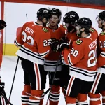 Sep 21, 2026; Chicago, Illinois, USA; Chicago Blackhawks defenseman Bowen Byram (24), third from right, celebrates with teammates after he scored the game winning goal during the overtime period against the Minnesota Wild at the United Center.