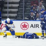 Oct 15, 2026; Toronto, Ontario, CAN; Toronto Maple Leafs center John Tavares (91) lays face down on the ice as Buffalo Sabres center Josh Norris (9) looks on during the third period at Scotiabank Arena.