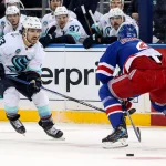 Dec 8, 2024; New York, New York, USA; Seattle Kraken left wing Brandon Tanev (13) tries to get past New York Rangers defenseman Braden Schneider (4) during the first period at Madison Square Garden.
