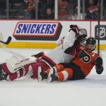 May 9, 2026; Philadelphia, Pennsylvania, USA; Philadelphia Flyers right wing Travis Konecny (11) collides with Carolina Hurricanes goaltender Frederik Andersen (31) during the first period in game four of the second round of the 2026 Stanely Cup Playoffs at Xfinity Mobile Arena.
