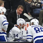 Oct 13, 2026; Salt Lake City, Utah, USA; Toronto Maple Leafs head coach Jim Hiller speaks with his team during a third period timeout against the Utah Mammoth at Delta Center.