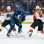 Dec 30, 2025; Vancouver, British Columbia, CAN; Philadelphia Flyers defenseman Nick Seeler (24) and defenseman Rasmus Ristolainen (55) check Vancouver Canucks forward Jake DeBrusk (74) in the second period at Rogers Arena.