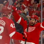 Oct 15, 2026; Detroit, Michigan, USA; Detroit Red Wings defenseman Anton Johansson (42) receives congratulations from center Dylan Larkin (71) after scoring in the second period against the Philadelphia Flyers at Little Caesars Arena.