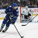 Sep 26, 2026; Vancouver, British Columbia, CAN; Vancouver Canucks left wing Jake DeBrusk (74) skates with the puck against Seattle Kraken during the third period at Rogers Arena.