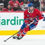 Oct 13, 2026; Montreal, Quebec, CAN; Montreal Canadiens center Kirby Dach (77) plays the puck against the Buffalo Sabres during the first period at Bell Centre.
