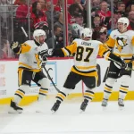 Mar 18, 2026; Raleigh, North Carolina, USA; Pittsburgh Penguins right wing Bryan Rust (17) celebrates scoring with center Sidney Crosby (87) and right wing Rickard Rakell (67) against the Carolina Hurricanes during the third period at Lenovo Center.