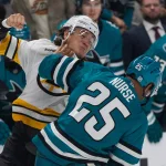 Oct 13, 2026; San Jose, California, USA; San Jose Sharks defenseman Darnell Nurse (25) and Boston Bruins defenseman Nikita Zadorov (91) fight during the third period at SAP Center at San Jose.