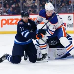 Sep 22, 2026; Winnipeg, Manitoba, CAN; Winnipeg Jets forward Walker Duehr (71) battles Edmonton Oilers forward Trent Frederic (10) for the puck during the first period at Canada Life Centre.
