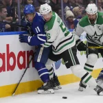 Jan 14, 2025; Toronto, Ontario, CAN; Dallas Stars defenceman Thomas Harley (55) pins Toronto Maple Leafs forward Max Domi (11) against the boards as Dallas Stars forward Jamie Benn (14) goes for the loose puck during the third period at Scotiabank Arena.