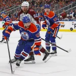 Apr 13, 2026; Edmonton, Alberta, CAN; Edmonton Oilers forward Issac Howard (53) and Colorado Avalanche forward Gabriel Landeskog (92) looks for a loose puck during the second period at Rogers Place. Mandatory Credit: Perry Nelson-Imagn Images