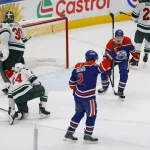 Hot mic catches offensive slur about goalies during Oilers-Wild game Oct 20, 2026; Edmonton, Alberta, CAN; The Edmonton Oilers celebrate a goal scored by defensemen Evan Bouchard (2) during overtime against the Minnesota Wild at Rogers Place. Mandatory Credit: Perry Nelson-Imagn Images