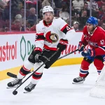 Oct 4, 2025; Montreal, Quebec, CAN; Ottawa Senators right wing Hayden Hodgson (42) drops the puck back onto the ice with his hand as Montreal Canadiens defenseman Jayden Struble (47) chases him during the second period at Bell Centre.