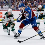 May 13, 2026; Denver, Colorado, USA; Colorado Avalanche defenseman Cale Makar (8) gets high sticked from Minnesota Wild right wing Danila Yurov (22) in the second period in game five of the second round of the 2026 Stanely Cup Playoffs at Ball Arena.