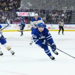 Oct 15, 2026; Toronto, Ontario, CAN; Toronto Maple Leafs right wing Easton Cowan (53) skates with the puck as Buffalo Sabres center Ryan McLeod (71) gives chase during the third period at Scotiabank Arena.