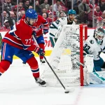 20 octobre 2026 ; Montréal, Québec, CAN ; le joueur de centre des Canadiens de Montréal, Kirby Dach (77), dispute la rondelle au gardien de but des Sharks de San Jose, Alex Nedeljkovic (33), durant la deuxième période au Centre Bell.