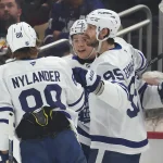 Nov 29, 2025; Pittsburgh, Pennsylvania, USA; Toronto Maple Leafs right wing William Nylander (88) and defenseman Oliver Ekman-Larsson (95) congratulate right wing Easton Cowan (53) on his goal against the Pittsburgh Penguins during the first period at PPG Paints Arena.
