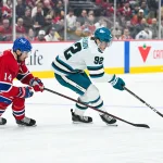 Oct 20, 2026; Montreal, Quebec, CAN; San Jose Sharks left wing Igor Chernyshov (92) plays the puck against Montreal Canadiens center Nick Suzuki (14) during the first period at Bell Centre.