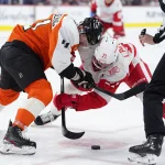 Apr 2, 2026; Philadelphia, Pennsylvania, USA; Philadelphia Flyers center Luke Glendening (41) and Detroit Red Wings center Dylan Larkin (71) battle for a faceoff in the first period at Xfinity Mobile Arena.