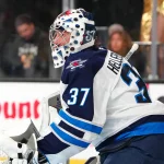 Apr 13, 2026; Las Vegas, Nevada, USA; Winnipeg Jets goaltender Connor Hellebuyck (37) warms up before the start of a game against the Vegas Golden Knights at T-Mobile Arena.